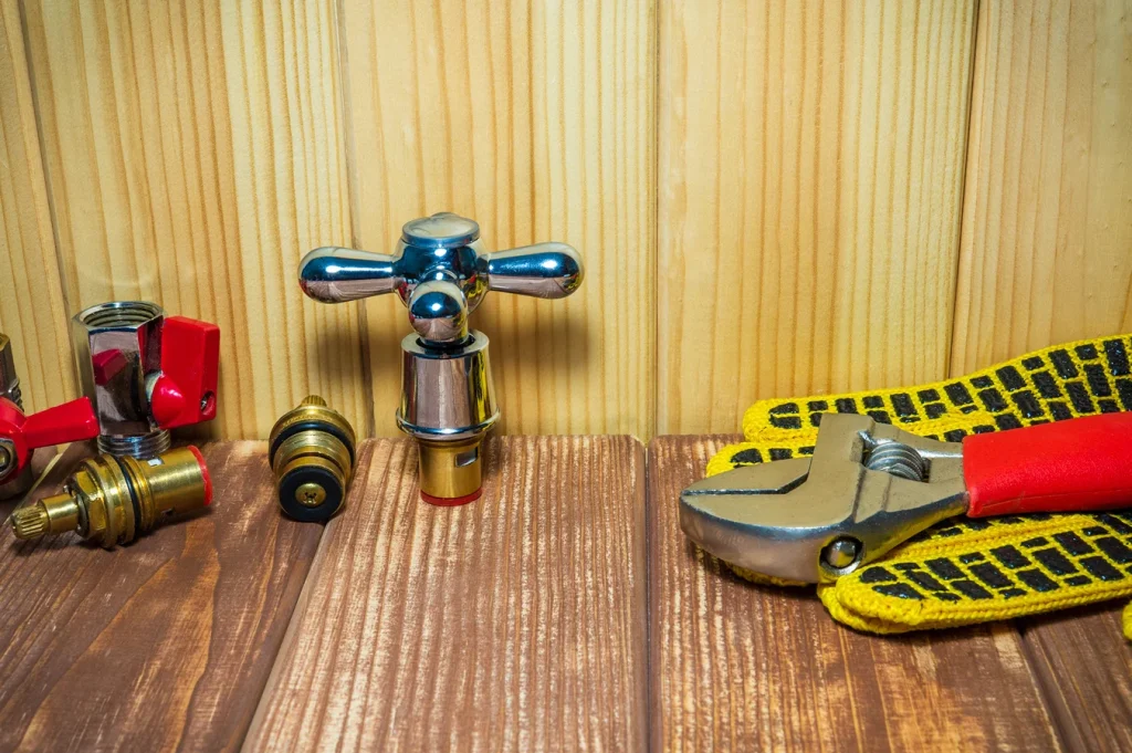plumbing repair supplies and tools on wooden antique background preparing for repairs photo
